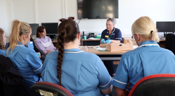 Andrea training community nursing staff on the care and maintenance of PICC (peripherally inserted central catheter) lines