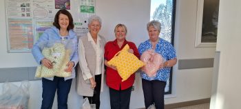 Newcastle Sewing Ladies have been putting needle through thread to bring comfort to those undergoing breast cancer treatment at the Ulster Hospital’s Macmillan Unit with a heartfelt donation of mastectomy cushions. Anna McNiff from the group explained how she and its members sew for charity and that twice yearly all sales from their work is donated to local charities and hospital units. “We sew for Oncology Units across Northern Ireland including the City Hospital, the Mandeville Centre in Craigavon and Ulster Hospital. We have also created quilt covers for incubators in the Neo Natal Unit in the Ulster Maternity,” said Anna. Anna added, “The Sewing Ladies were delighted to meet with the Macmillan Unit staff and we hope the mastectomy cushions provide comfort for those patients undergoing treatment.” Ward Sister Angela Berry said, “Our patients really appreciate these cushions, they are so well made and we want to say a huge thank you to the Newcastle Sewing Ladies for their very kind donation.”