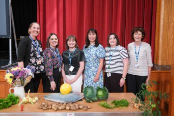 Suzanne McCombe (Specialist Occupational Therapist, South Eastern Trust), Bridgene Savage (Senior Manager, Mental Health, South Eastern Trust), Emma McEvoy (Business Assurance Support Manager), Roisin Coulter (Chief Executive), Nicola Maybin (Mental Health Information & Records Manager, South Eastern Trust) and Clare McCawley (Garden Manager, South Eastern Trust) with some of the flowers and produce from the gardens