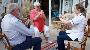 Lisburn husband and wife Ken Brown and Carol McGuinness with South Eastern Trust Falls Lead Co-ordinator Sarah Moran demonstrating resistance band training as part of the team’s Falls Prevention classes